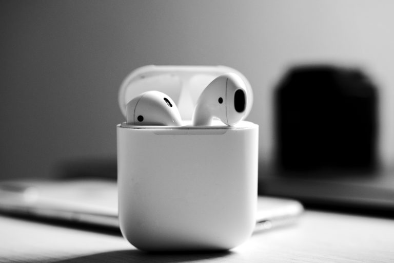 White earbuds with charging case displayed