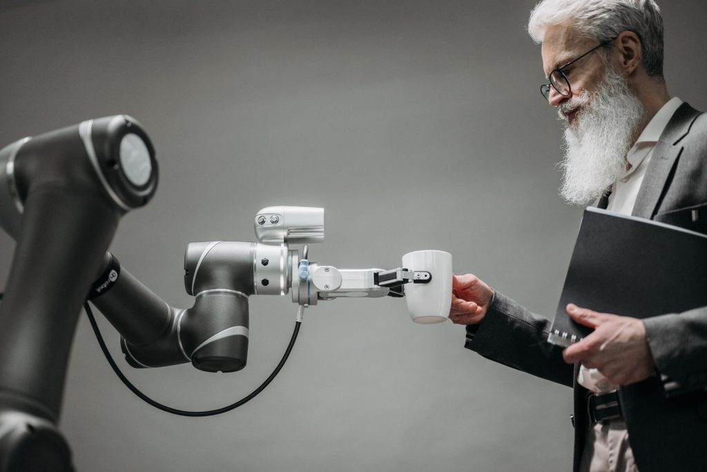 A human and a robot collaborating on a digital interface, symbolizing AI's impact on work