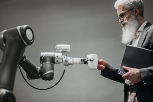 A human and a robot collaborating on a digital interface, symbolizing AI's impact on work