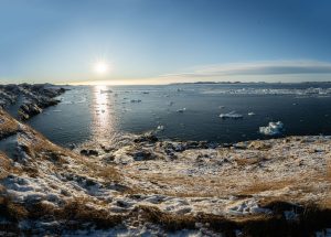 Beautiful snowy coastline and icy waters in Nuuk, Greenland under the bright winter sun