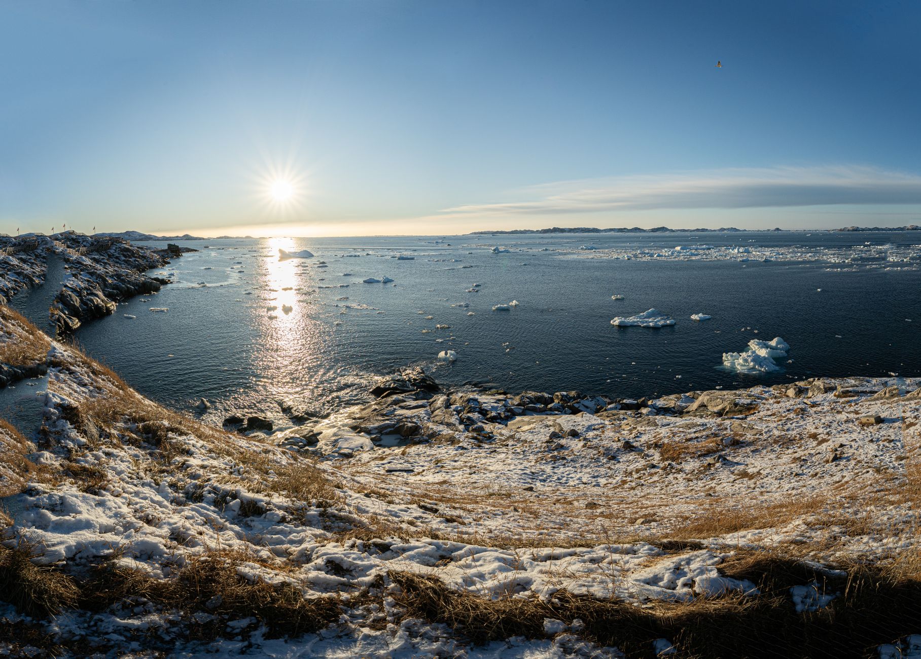 Beautiful snowy coastline and icy waters in Nuuk, Greenland under the bright winter sun