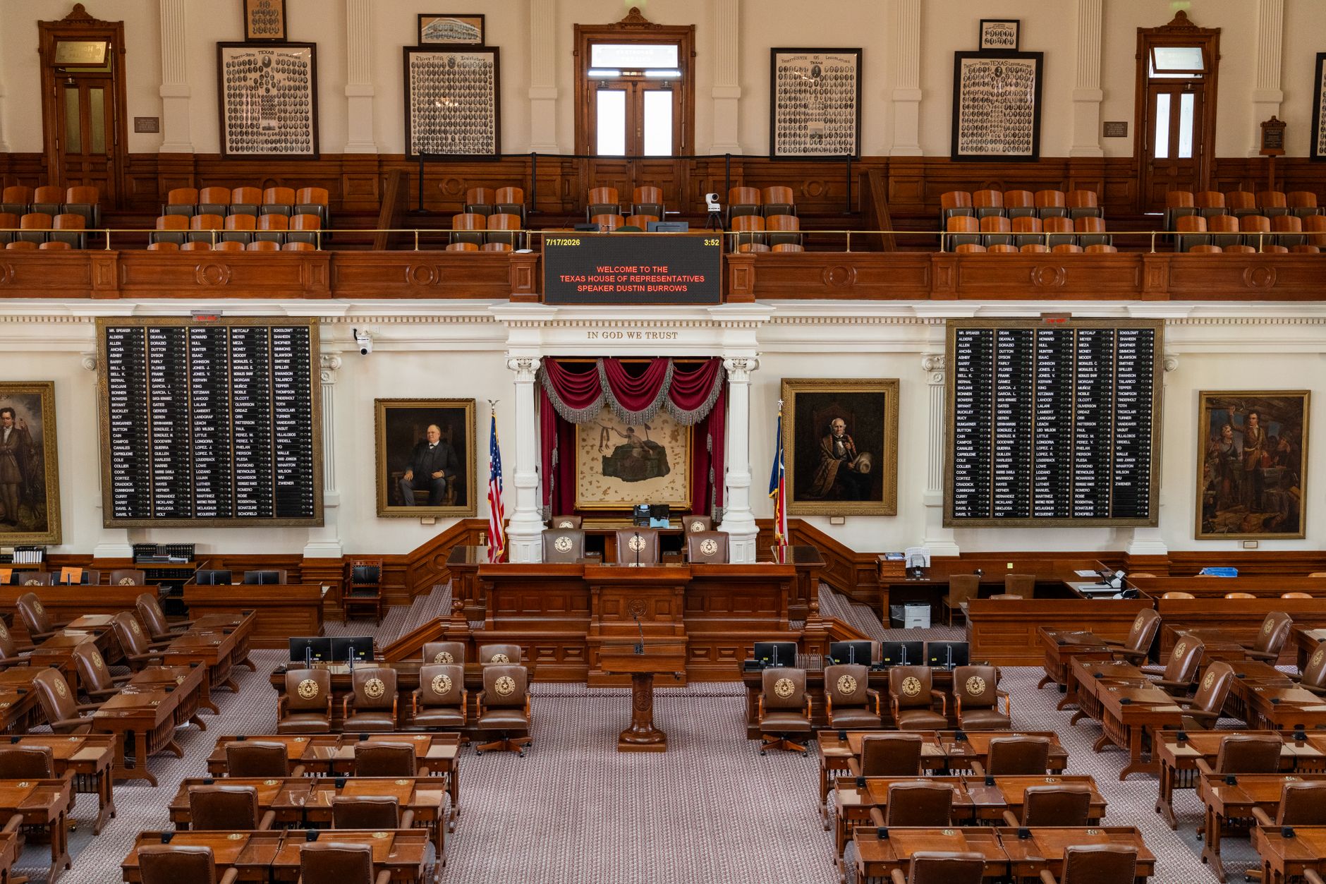 The Texas House of Representatives chamber, featuring legislative seats and historical portraits
