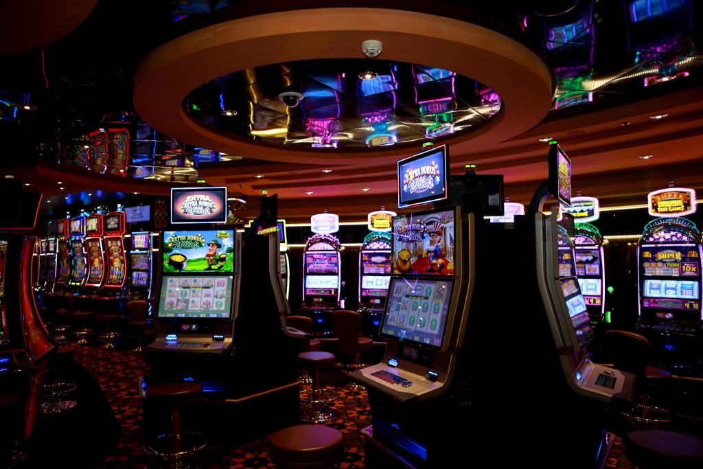 Rows of illuminated slot machines on a casino floor