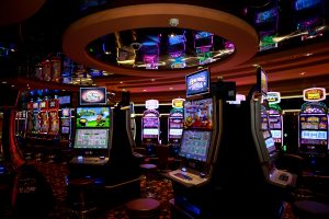 Rows of illuminated slot machines on a casino floor