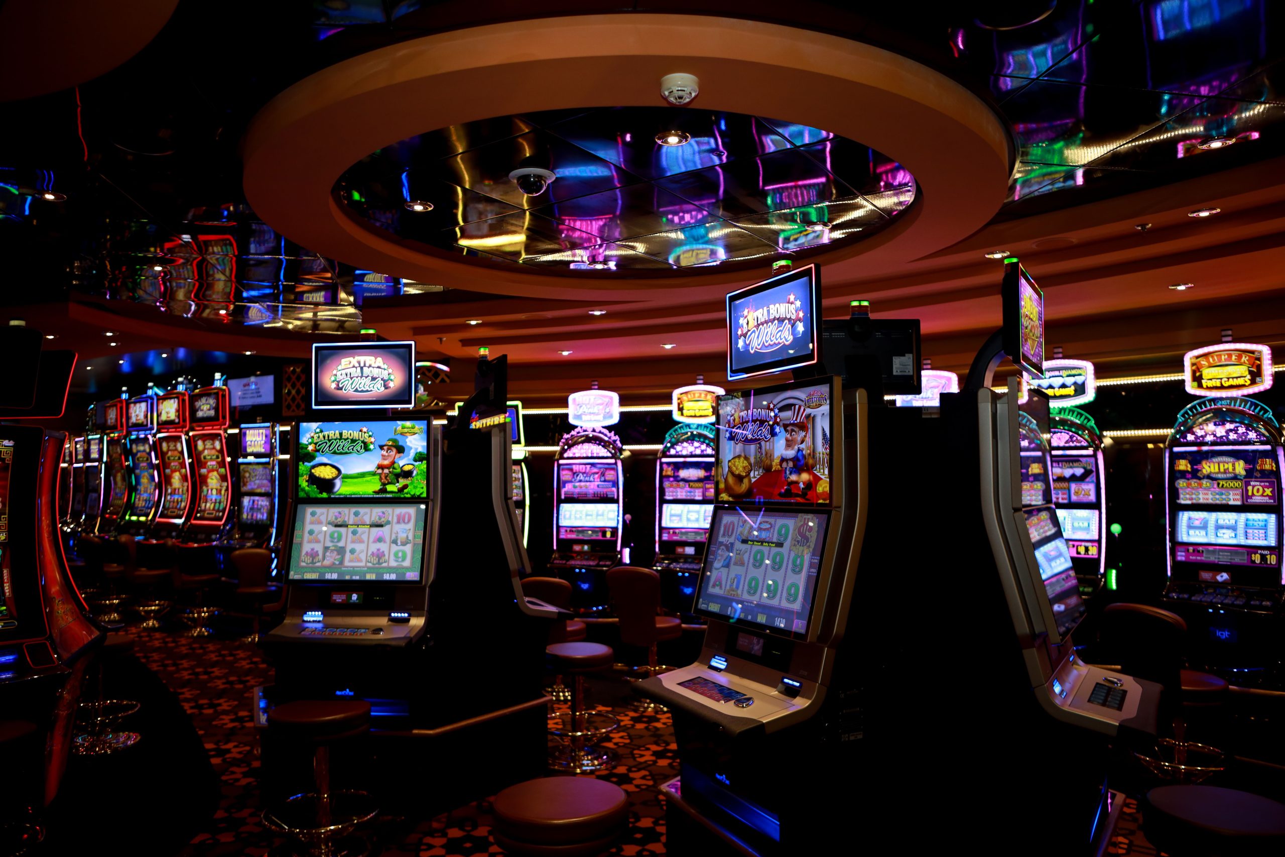 Rows of illuminated slot machines on a casino floor