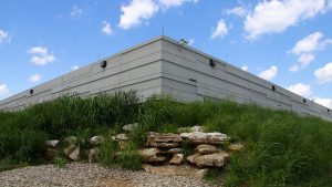 The concrete exterior of Indiana University’s data center behind landscaped grasses and rocks