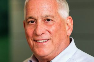 Walter Isaacson smiling in a close-up portrait